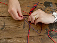 Tying a spiral half-hitch sennit bracelet in coloured cotton cord, HesFes 2012